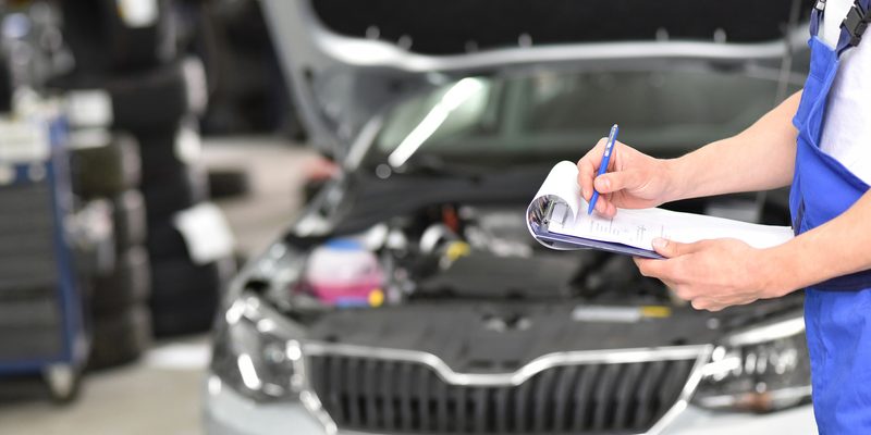 service and inspection of a car in a workshop - mechanic inspects the technology of a vehicle for function and safety